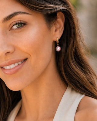 Close-up of 9–9.5mm pink Freshwater pearl huggie earrings