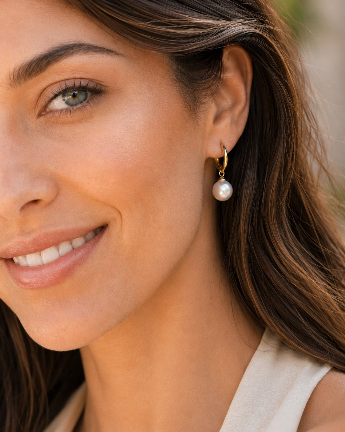 Close-up of 8.5–9mm white Freshwater pearl huggie earrings