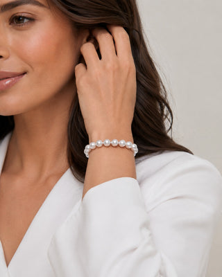 Prestige Pearl hand-knotted white Akoya pearl bracelet worn on a woman's wrist, featuring 6-6.5mm round pearls.