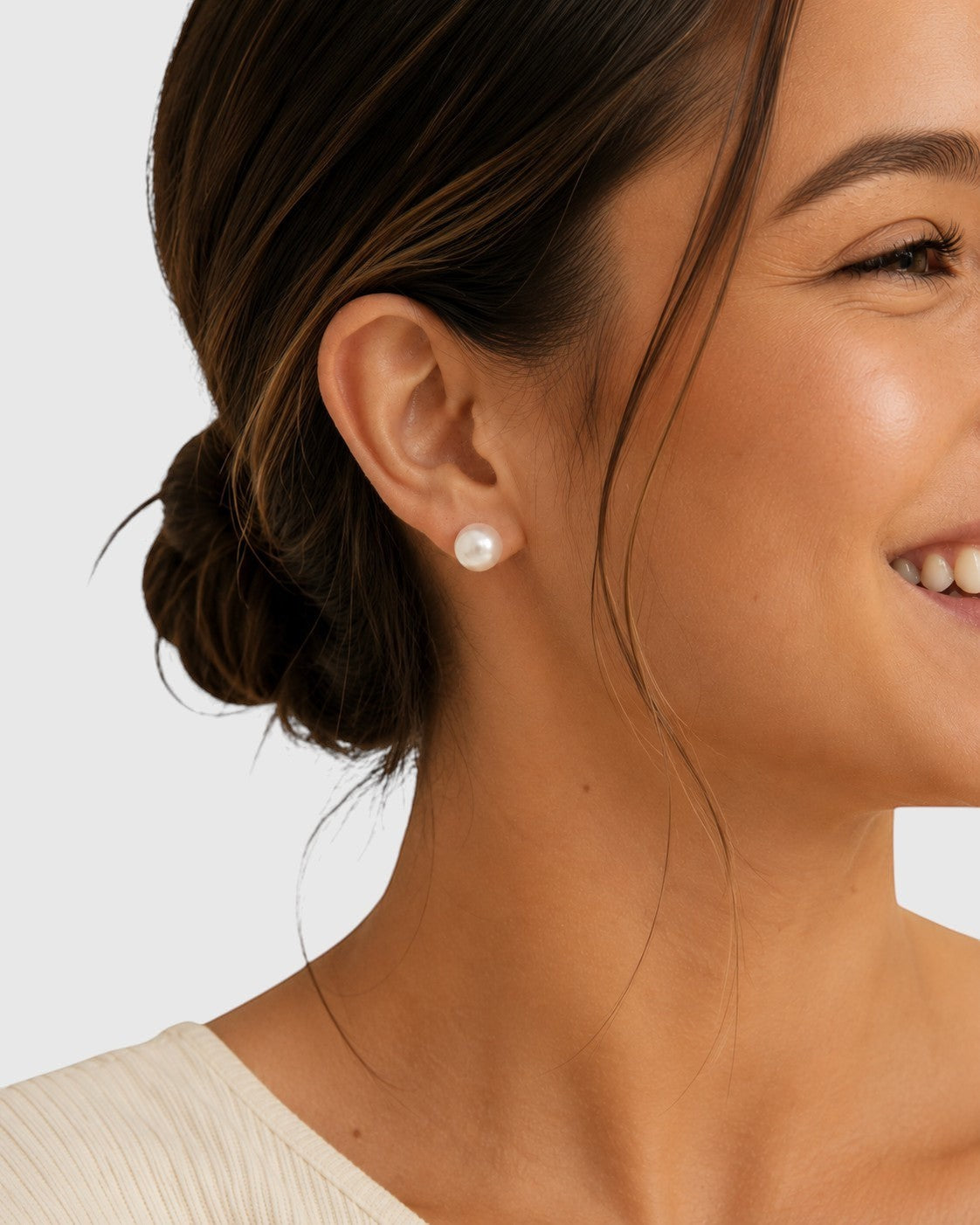 Prestige Pearl 9-9.5mm white round Akoya pearl stud earrings worn by a smiling woman