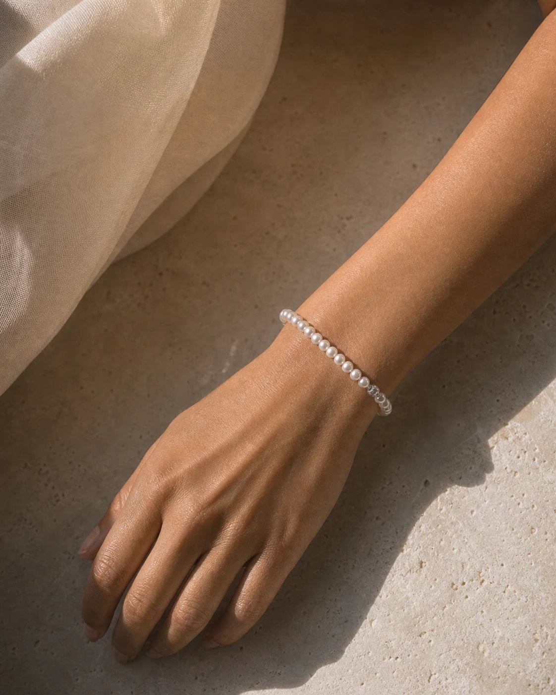 Woman wearing a delicate white pearl bracelet