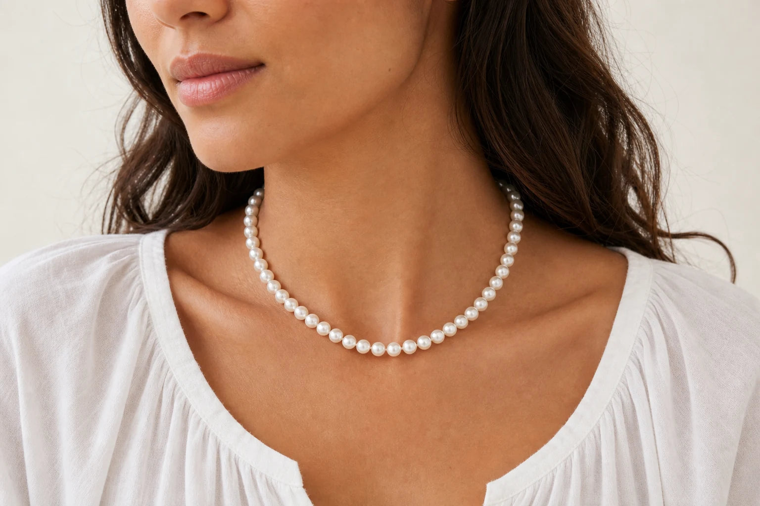 Model wearing a classic white pearl necklace